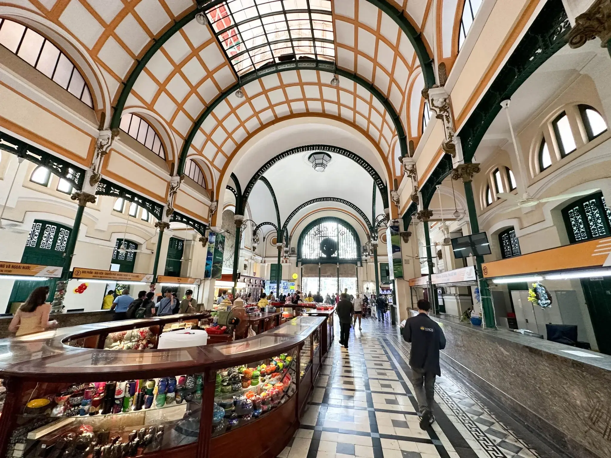 Interior of Central Post Office Saigon with arched ceiling and historic maps
