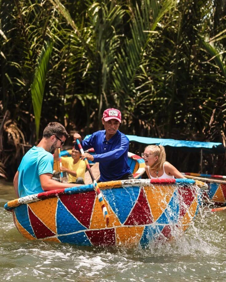 Boatmen performing folk dance on basket boat Hoi An